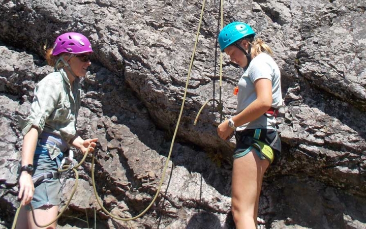 girls learn rock climbing skills 